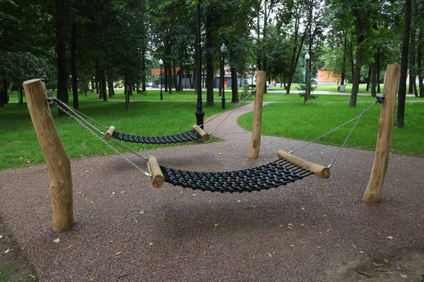 istock Two hammocks on chains between poles in a city park. 1711267175
