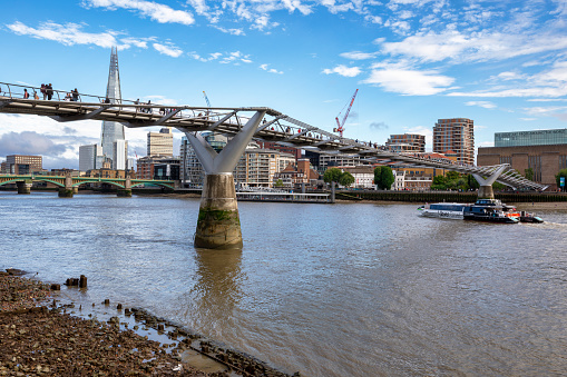 London, UK - Aug 14, 2023: People cross the Millennium Bridge in the direction of the Modern Art Gallery 'Tate Modern' on  Aug 14, 2023 in London.