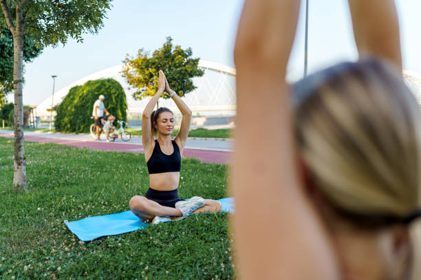 istock Two young women meditating at the park 1711300270