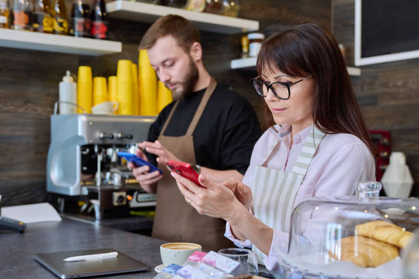 istock Team male and woman talking, working, using phone, coffee shop 1711302715