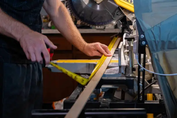 Cutting material on a skill-saw, measuring tape, carpentry