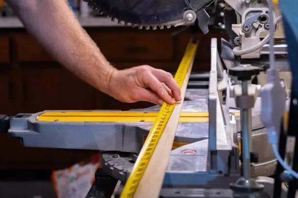 Cutting material on a skill-saw, measuring tape, carpentry