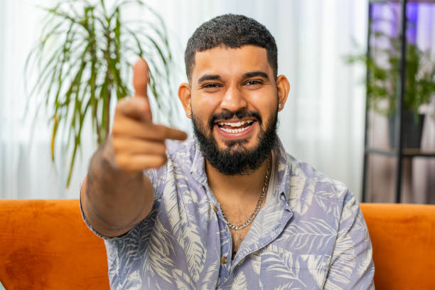 istock Happy Indian man smiling, pointing to camera, choosing lucky winner, indicating, inviting, approve 1711321761