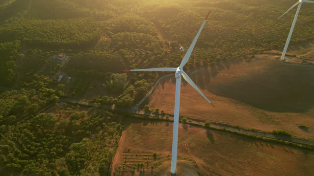 Aerial view   of a wind Turbine in a rural scene, at the end of the day in the golden hour