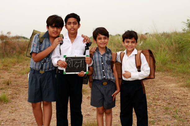 istock Elementary students standing outdoor in nature holding writing slate in hands 1711330984