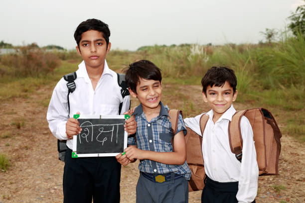 istock Elementary students standing outdoor in nature holding writing slate in hands 1711330990