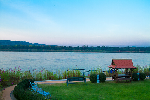 Promenade of River Mountain Resort at Mekong river in sunset. Scenery and landscape in and around Chiang Khan in Loei province. In background is Laos