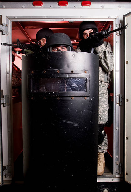 SWAT Team exiting SWAT unit exiting truck riot shield stock pictures, royalty-free photos & images