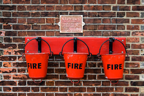 A row of fire buckets on an old fashioned railway station in England.