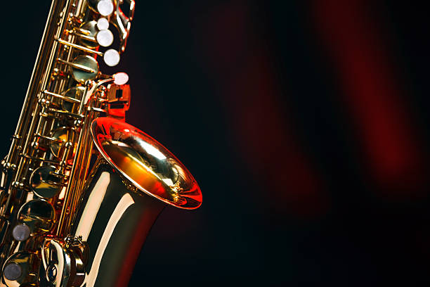 Saxophone with copy space Alto saxophone on a red and black background with space for copy. Shot with Canon EOS 1Ds Mark III. big band jazz stock pictures, royalty-free photos & images
