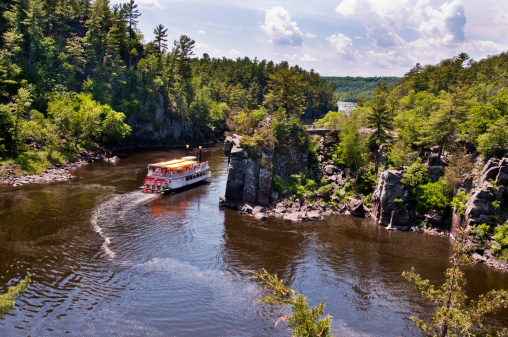 A Paddle Boat travels down the scenic St. Croix River. The St. Croix River borders Minnesota and Wisconsin.