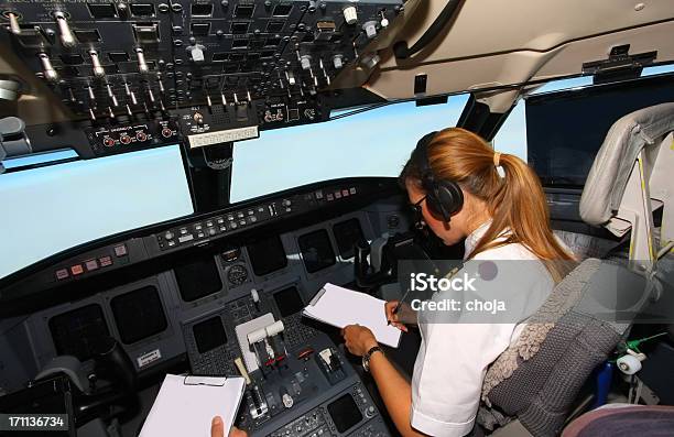 Commercial Jet Flyinbeautiful Woman Pilot Checking Data Stock Photo - Download Image Now