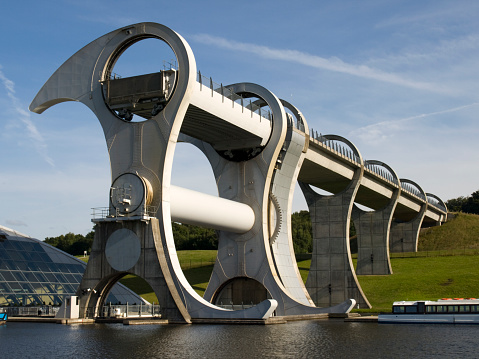 The Falkirk Wheel, named after the nearby town of Falkirk in Central Scotland, is a rotating boat lift connecting the Forth and Clyde Canal with the Union Canal. The two canals were previously connected by a series of 11 locks, but by the 1930s these had fallen into disuse, were filled in and the land built upon.