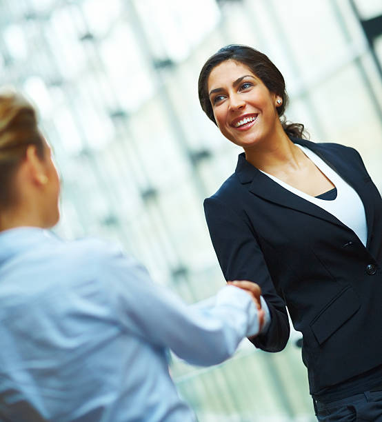 istock Two businesswomen shaking hands and smiling 171136853
