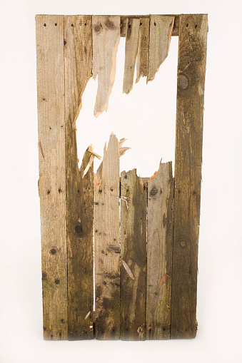 A smashed fence on a white background, ideal to add something or someone coming through the hole.