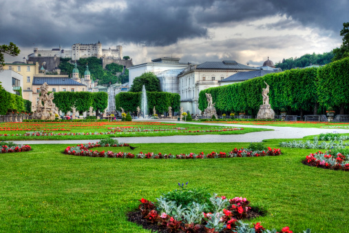 HDR image of Salzburg's famous Mirabell Gardens with the Hohensalzburg fortress and old town in the background.