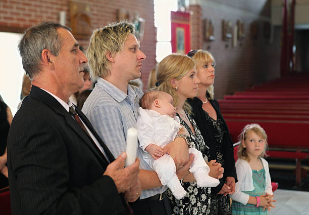 Happy parents and grandparents waiting for baptism of little boy Happy family waiting for baptism. baptism photos stock pictures, royalty-free photos & images