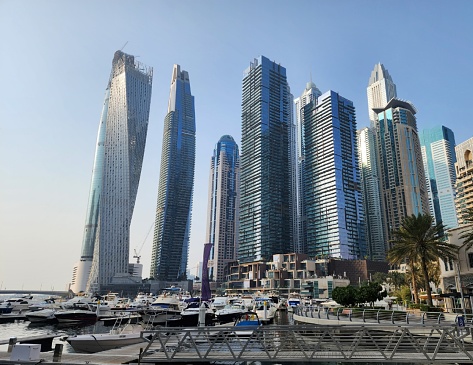 The Dubai Marina sits in the shallow coastline, the city sprawling around it.