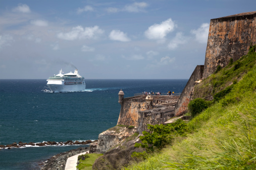 A Cruise Ship enters San Juan Harbor, passing the fortress of El Morro.