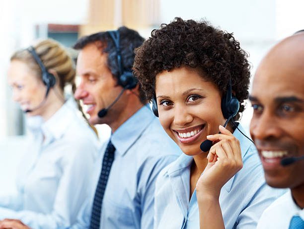 istock Female telephonist working with her colleagues and smiling 171137876