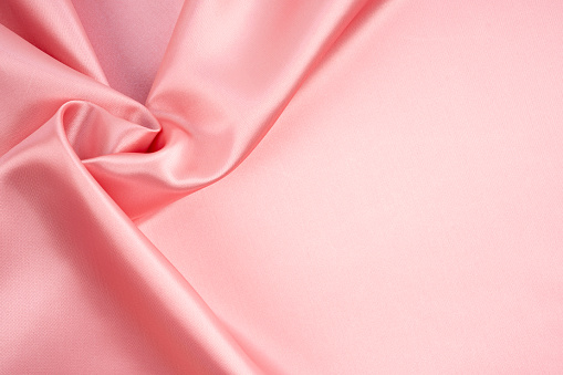 Rose Gold silk satin fabric texture as background.