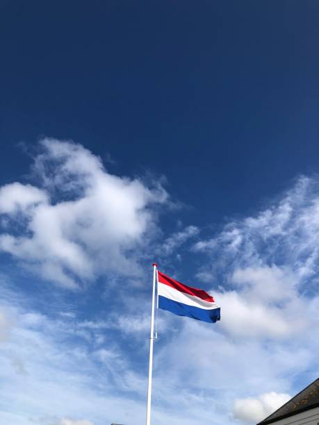 istock A Dutch flag against a blue white sky 1711433613