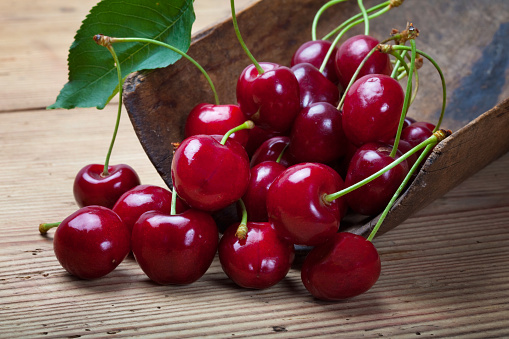 Cherries on wooden table.