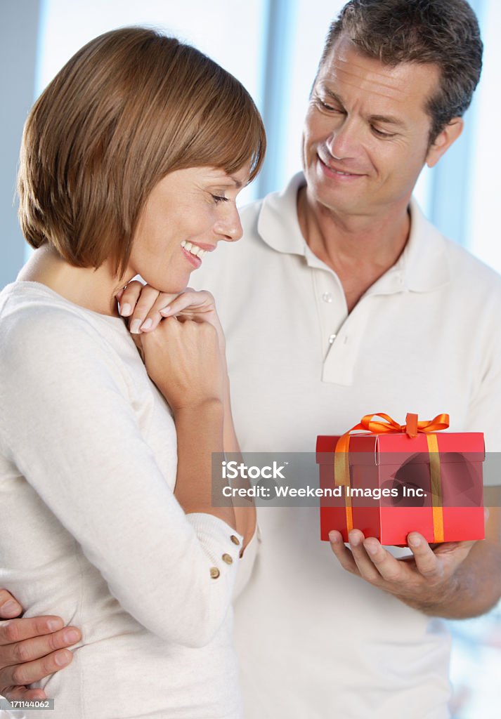 Woman getting a  gift  senior's couple with gift  40-44 Years Stock Photo