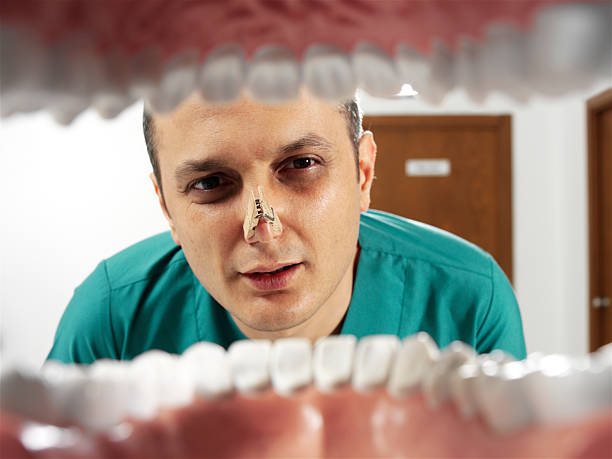 дурной запах изо рта - mouth open human teeth doctor dental drill стоковые фото и изображения
