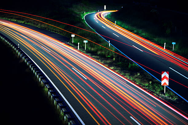 Car light trails on highway junction at night