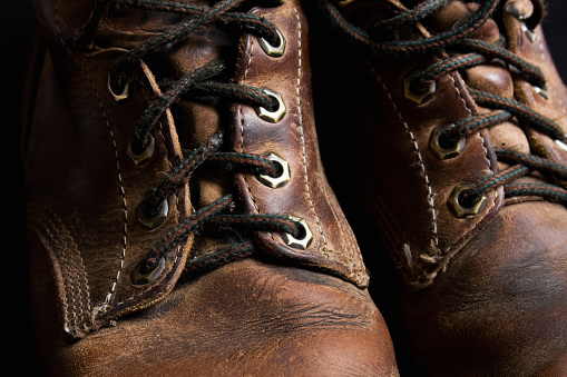 Close-up view of a pair of used leather work boots.