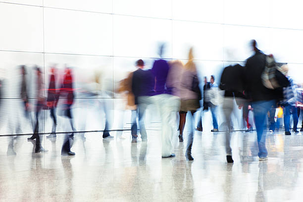 Crowd of People Walking Indoors Down Walkway, Blurred Motion crowd of people walking down modern interior, blurred motionClick here to view more related images: elevated walkway photos stock pictures, royalty-free photos & images