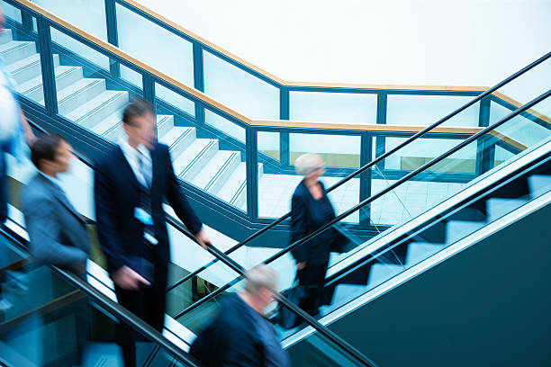 istock Business people on escalators, blurred motion 171145710