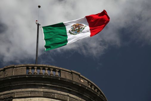 Mexican flag waving on top of Chapultepec Castle in Mexico City
