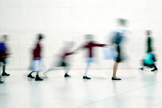 istock School children walking with teacher, motion blur 171146015
