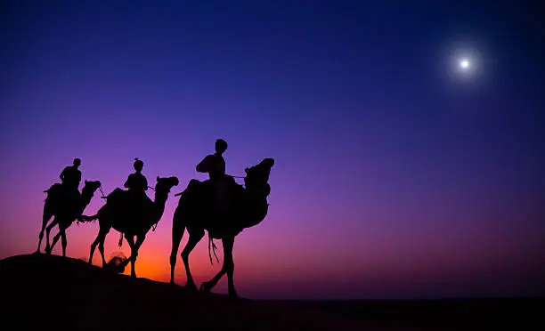 Three Wise Men following a star to Bethlehem. Rajasthan desert, India.