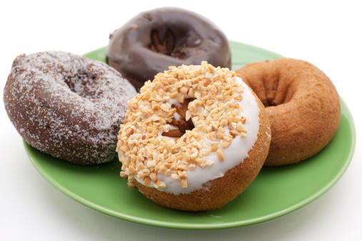 plate of four donuts on white background