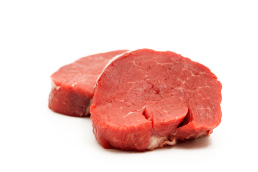 close-up of two filet mignon on white background