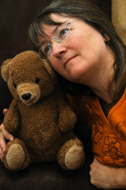istock woman nostalgic with teddy bear 171146176