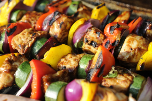 Chicken and vegetable kebab char grilling on a barbecue