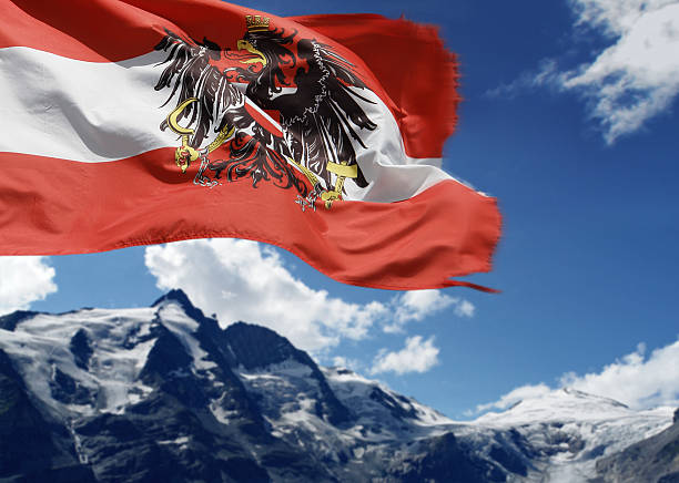 Austrian Alps Grossglockner Peak (Austria's highest mountain 3,798 m/12,461 feet) and Austrian Flag. Background out of focus. SEE MY OTHER PHOTOS from AUSTRIA: grossglockner stock pictures, royalty-free photos & images