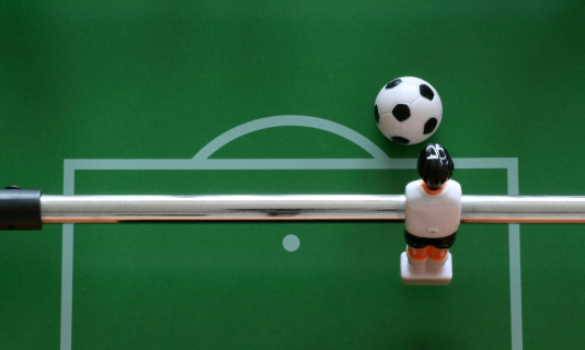 close-up of a goalkeeper from a table soccer game ready to kick the ball