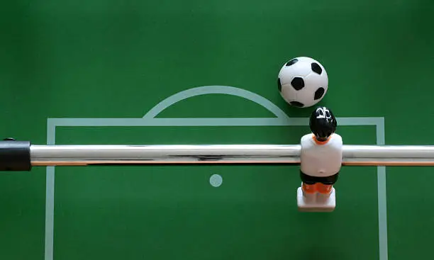 close-up of a goalkeeper from a table soccer game ready to kick the ball