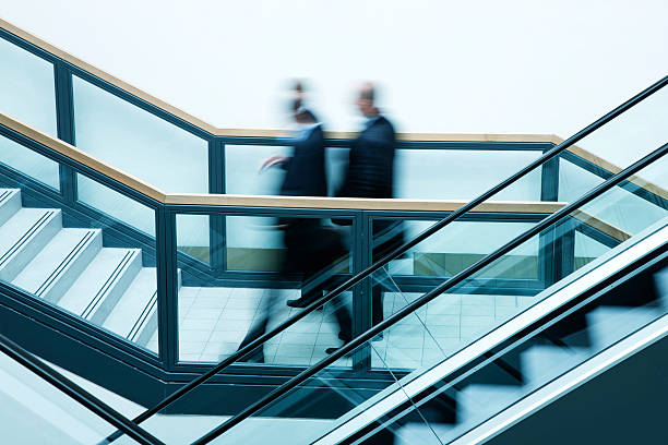istock Business people on escalators, blurred motion 171146704