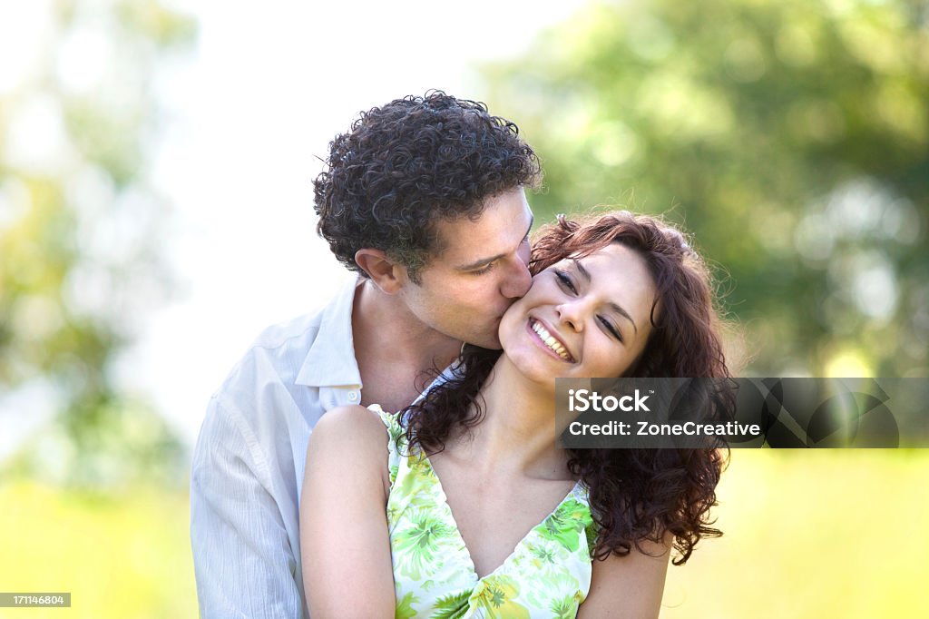 A beautiful, young couple hugging and kissing young beautiful couple in love outdoor Adult Stock Photo