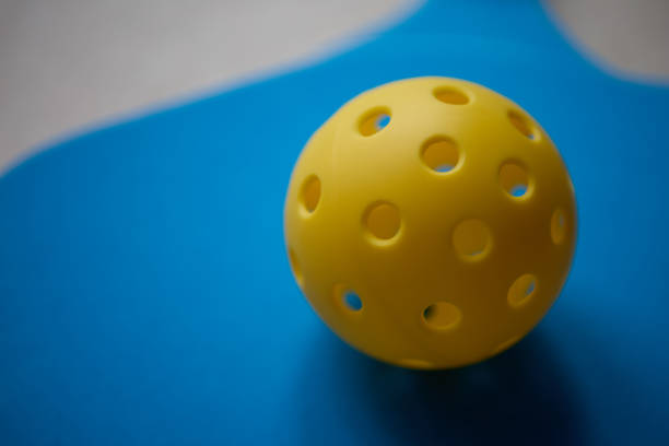 istock Perforated plastic ball for pickleball in close up 1711469925