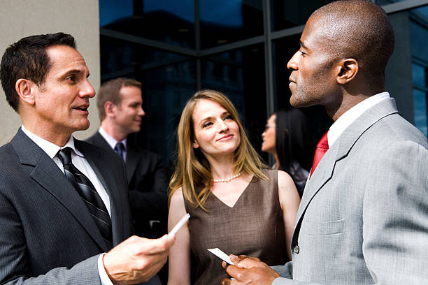 People exchanging business cards stock photo