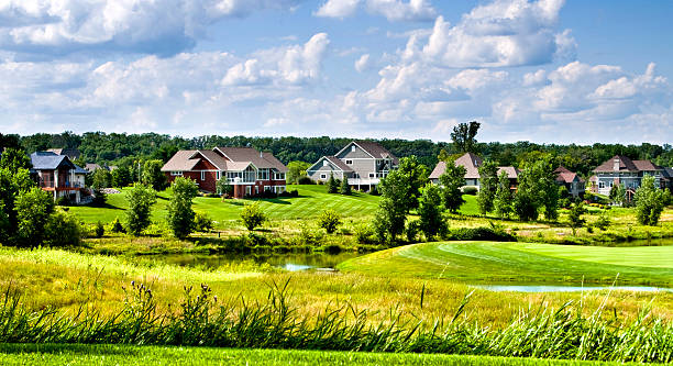 Country Club Homes A row of beautiful, luxury homes on rural Wisconsin Country Club Golf Course. luxury-villa-view stock pictures, royalty-free photos & images