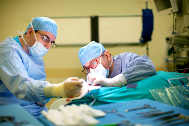 Doctors performing surgery stock photo