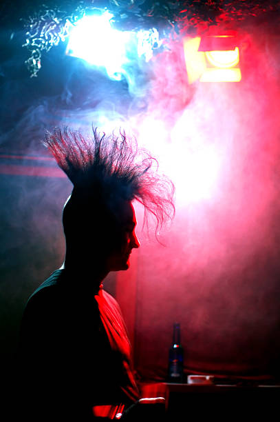 standing at the bar silhouette of a gothic/punk guy with a mohawk haircut in a discotheque vex nightclub stock pictures, royalty-free photos & images